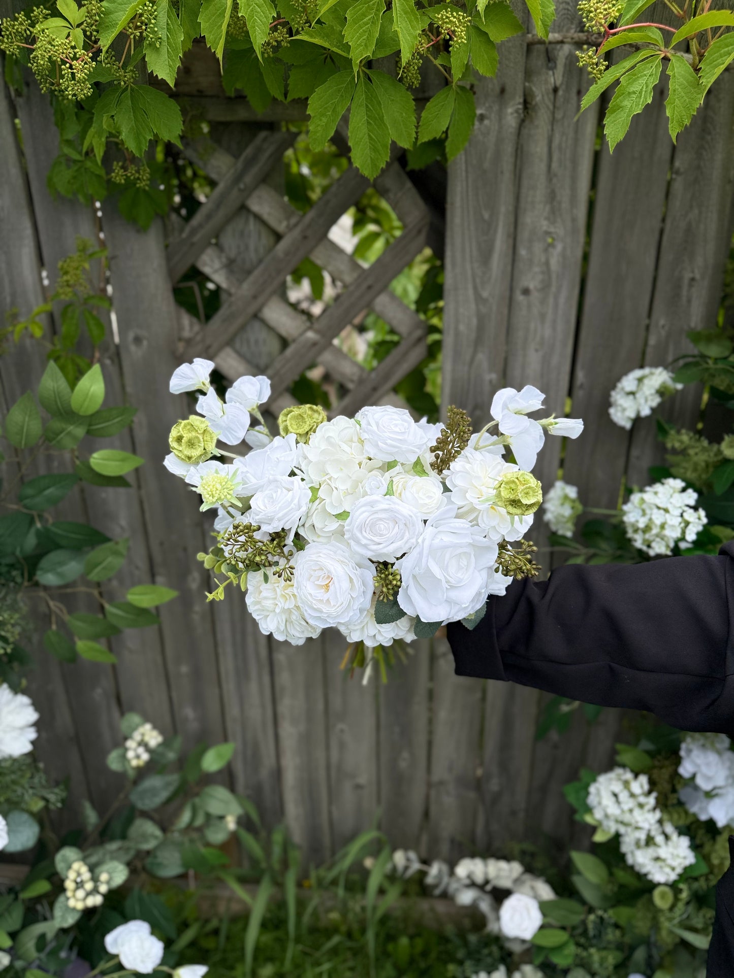 Classic modern faux white bridal bouquet with roses, dahlias, hydrangeas, scabiosa balls and berries
