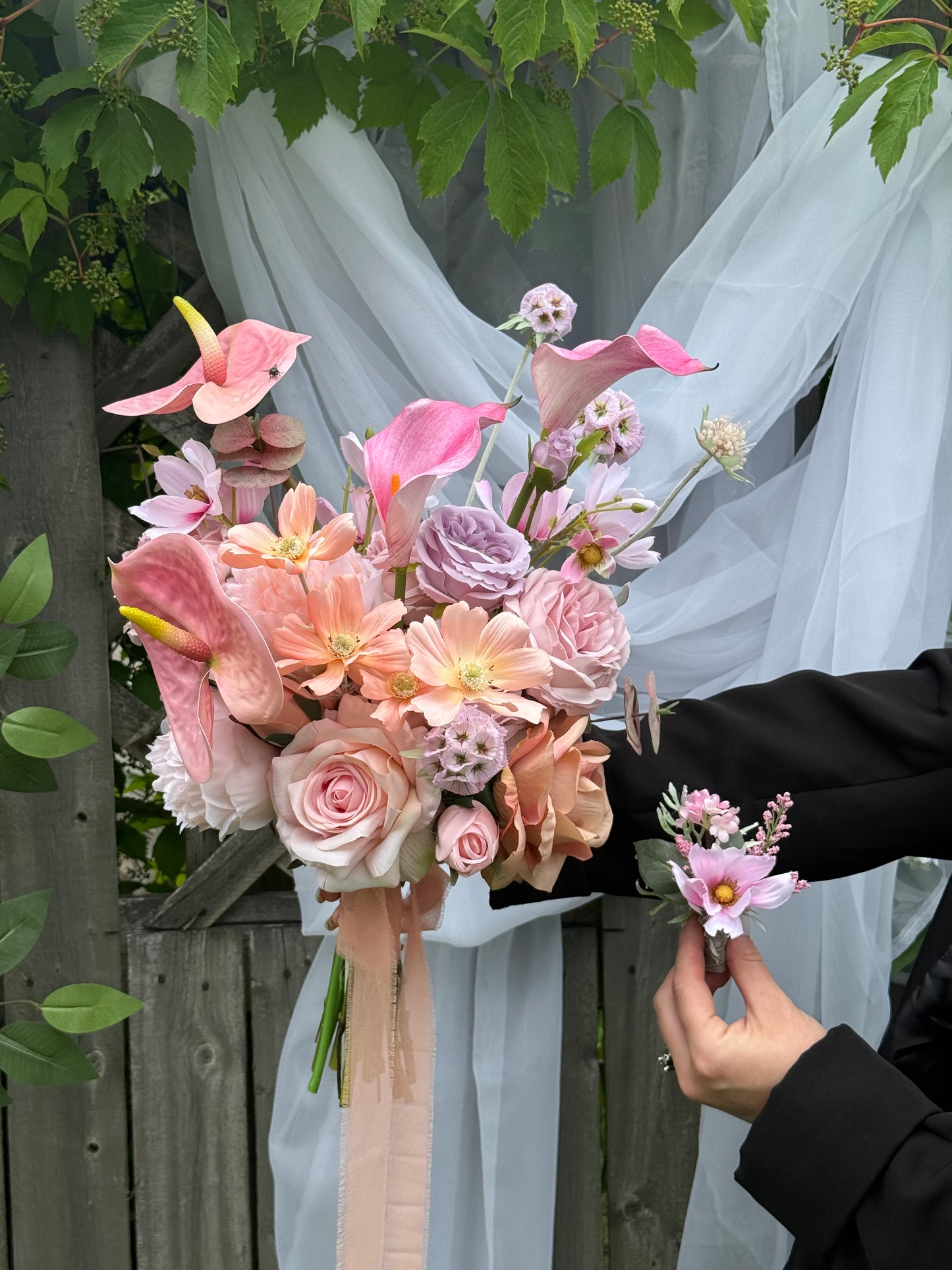 Pink and peach bridal bouquet with anthurium and calla lilies