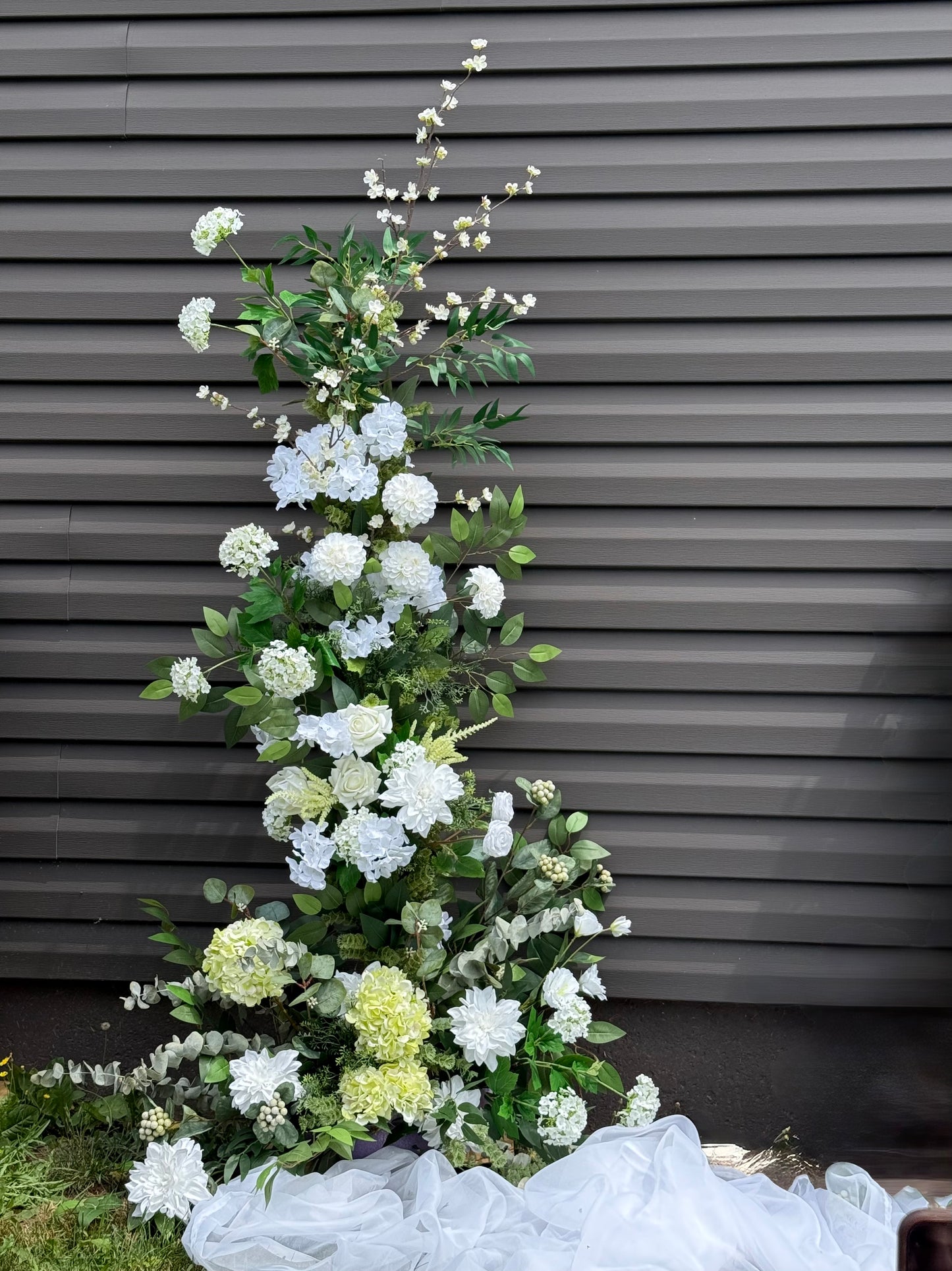 Garden white classic broken arch with dahlias, roses, eucalyptus and brunches