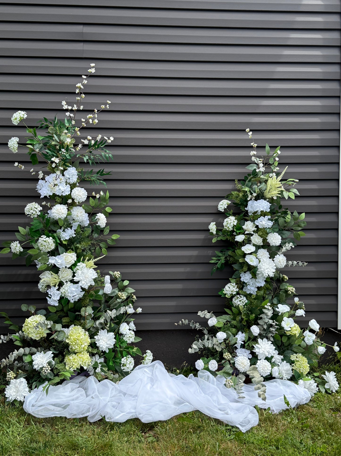 Garden white classic broken arch with dahlias, roses, eucalyptus and brunches