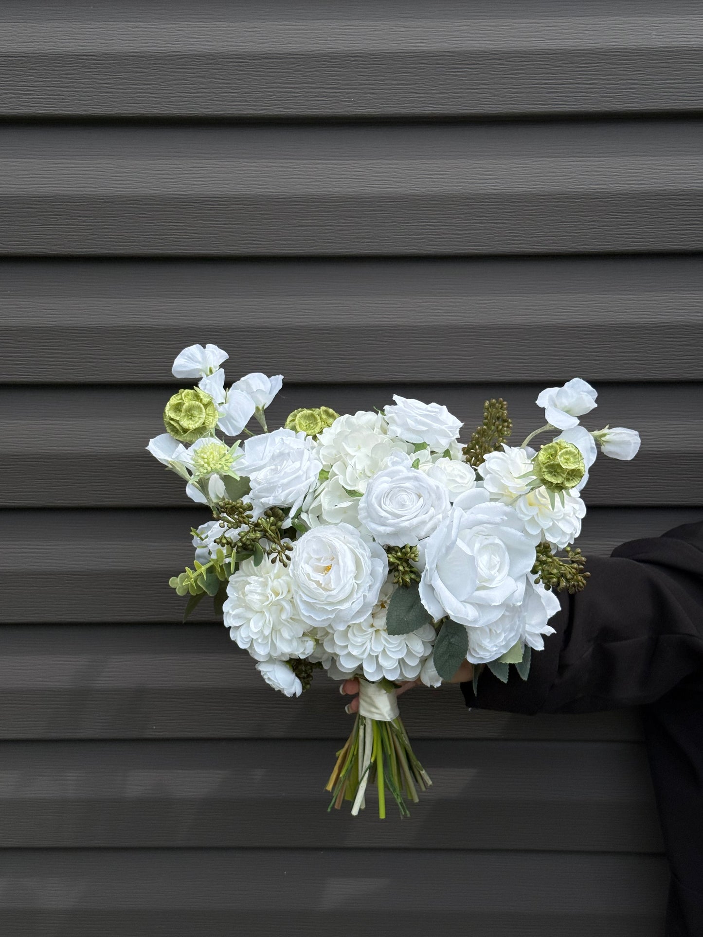 Classic modern faux white bridal bouquet with roses, dahlias, hydrangeas, scabiosa balls and berries 
