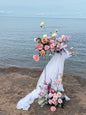 Ocean wedding, broken arch, bright pastel floral decor, golden stands