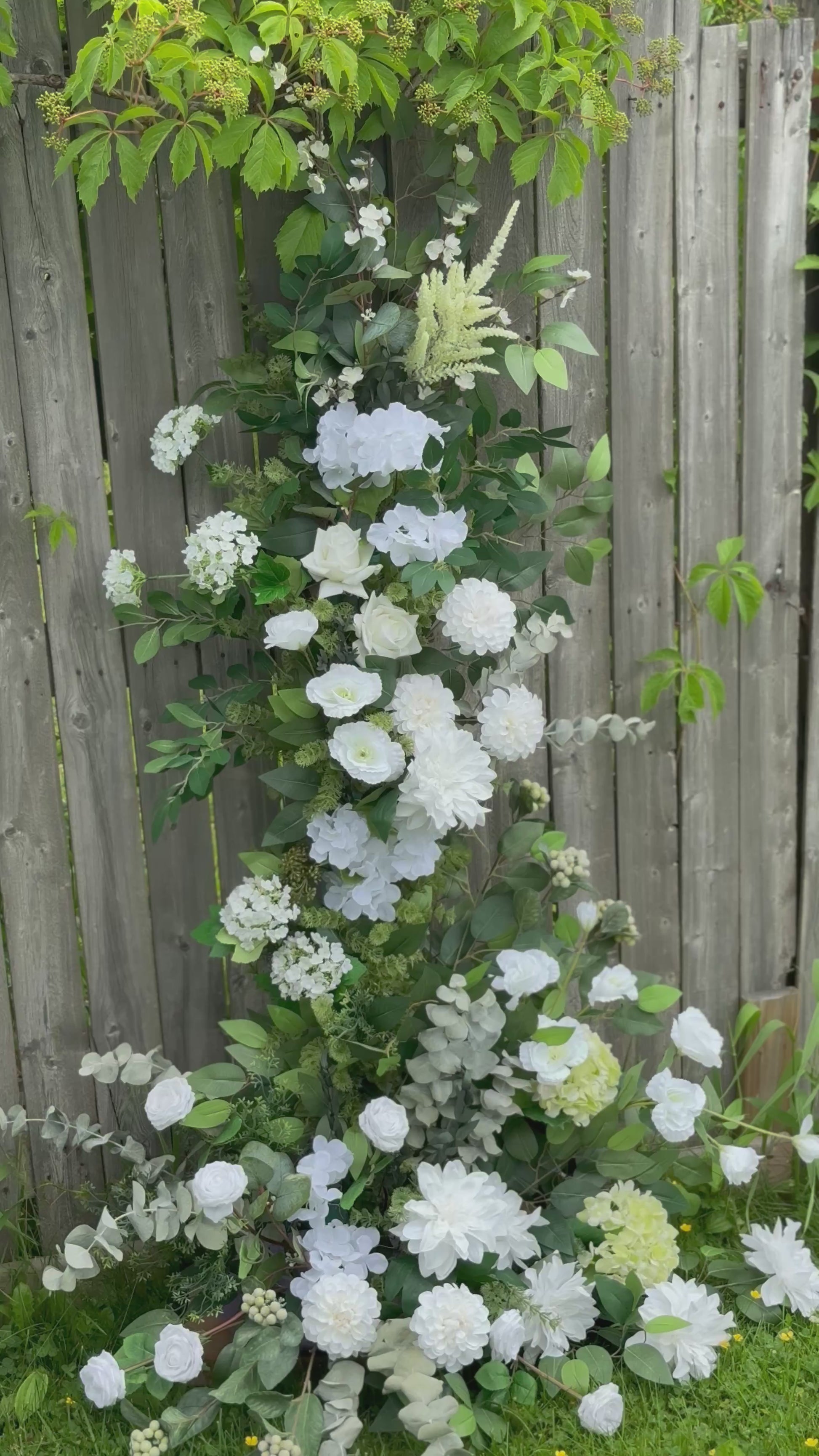 Garden white classic broken arch with dahlias, roses, eucalyptus and brunches 