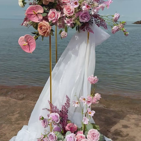 Ocean style pink and purple wedding golden stand with ranunculus, anthurium, roses and wild flowers